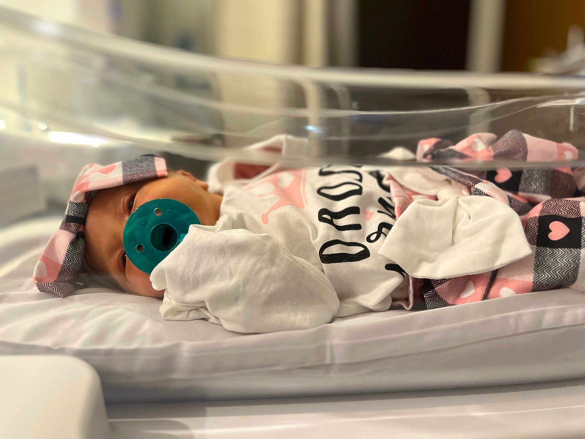 Rayliana joined the competition — help win amazing prizes! newborn, baby, pacifier, blanket, hospital, bassinet, infant, headband, clothing, bed, sleeping, cute, swaddled, pink, white, heart_pattern, closeup, indoor, person, portrait