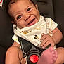 baby, smiling, car_seat, infant, bib, foot, hand, face, cute, happy, child, seat_belt, clothing, diaper, skin, person, portrait, indoor, closeup, expression