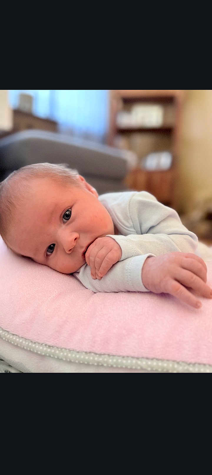 Brody joined the competition — help win amazing prizes! baby, infant, newborn, pillow, blanket, hand, eyes, face, lying_down, indoor, nursery, couch, soft, portrait, closeup, skin, clothing, cozy, gaze, small_fingers