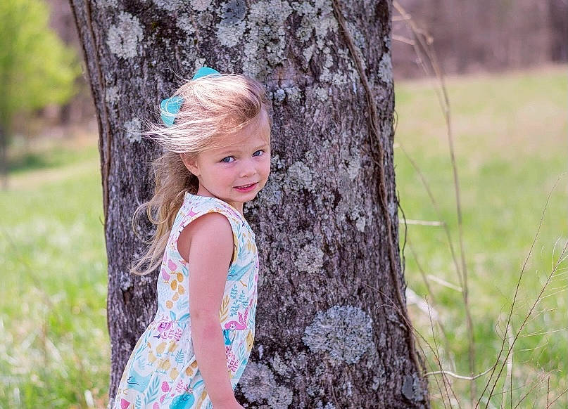 Elaina joined the competition — help win amazing prizes! child, dress, eye, forest, fun, grass, hair, happy, head, joy, leisure, long_hair, people_in_nature, person, plant, skin, smile, toddler, tree, trunk