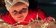 Piper joined the competition — help win amazing prizes! baby, bow, carpet, child, closeup, crawling, curious, face, festive, glowing, headwear, holiday, indoors, lights, portrait, red_clothing, smiling, soft_light, string_lights, warm