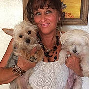 Fluffylynn is registered to the contest to win money with this photo: bracelet, casual, cute, dog, earrings, face, fluffy_dog, happy, holding, indoor, jewelry, painting, person, pet, portrait, short_hair, smiling, wall, white_clothing, woman