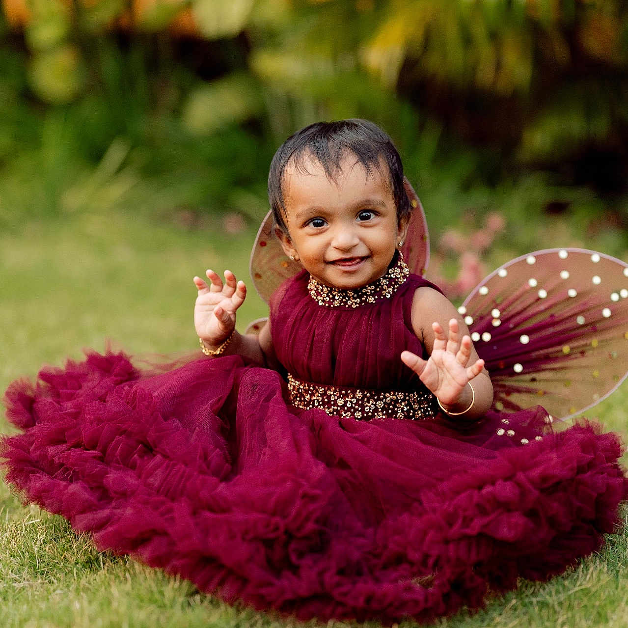Liora Mariyam joined the competition — help win amazing prizes! baby, child, costume, cute, dress, fairy_wings, fashion, garden, grass, greenery, happy, jewelry, nature, outdoor, playful, portrait, sitting, smile, toddler, young_child