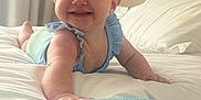 Ivy-Rose is registered to the contest to win money with this photo: baby, smiling, bed, blue_clothing, infant, happy, indoor, crawling, cute, child, person, furniture, blanket, pillow, room, skin, head, hand, portrait, sleepwear