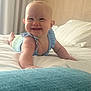 baby, smiling, bed, blue_clothing, infant, happy, indoor, crawling, cute, child, person, furniture, blanket, pillow, room, skin, head, hand, portrait, sleepwear