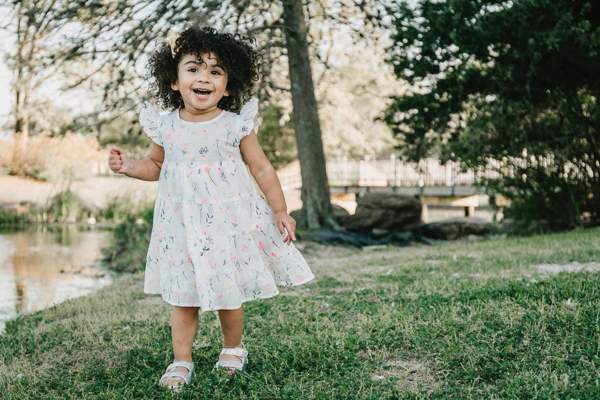 Athena is registered to the contest to win money with this photo: day_dress, dress, flash_photography, grass, happy, joy, leaf, leisure, meadow, one_piece_garment, pattern, people_in_nature, person, plant, sleeve, smile, street_fashion, sunlight, tints_and_shades, toddler