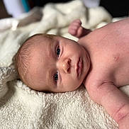 Kyren joined the competition — help win amazing prizes! baby, newborn, infant, skin, face, eyes, blanket, soft, cozy, lying_down, cute, child, portrait, expression, indoor, human, peaceful, naked_torso, small_hand, closeup