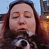 woman, dog, puppy, pet, portrait, selfie, outdoor, evening, dusk, street, building, rooftop, streetlight, sunglasses, red_hair, nose_ring, fluffy_fur, licking, affectionate, close_up