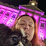 Kimy participe au concours pour gagner de l'argent avec cette photo : woman, person, dog, puppy, pet, selfie, portrait, face, long_hair, nose_ring, outdoor, night, building, architecture, historic_building, illuminated, purple_lighting, city, close_up, companion