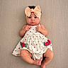 baby, infant, child, bow_headband, watermelon_pattern, dress, cute, lying_down, texture_background, skin, foot, hand, pout, adorable, fashion, portrait, indoors, small_person, expression, headwear