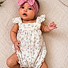 Kallie joined the competition — help win amazing prizes! baby, infant, child, headband, bow, romper, floral_pattern, blanket, textured, laying_down, cute, curious, wide_eyes, open_mouth, skin, arms, legs, soft_lighting, indoors, portrait