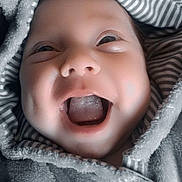 Ohana participe au concours pour gagner de l'argent avec cette photo : baby, smiling, face, hood, blanket, striped, dimples, happy, closeup, child, mouth_open, joyful, cozy, infant, cute, soft_texture, portrait, expression, wrapped, warm