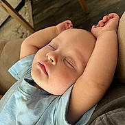 Sonny joined the competition — help win amazing prizes! baby, sleeping, arms_up, blue_shirt, infant, peaceful, face, closed_eyes, chubby_cheeks, indoor, couch, wooden_floor, relaxing, soft_lighting, portrait, child, toddler, casual_clothing, home, resting