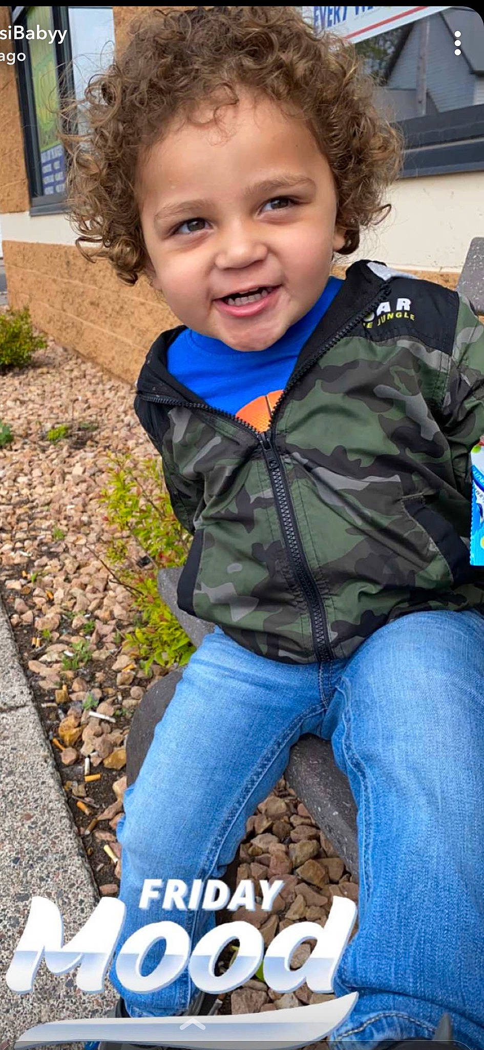 Emil is registered to the contest to win money with this photo: clothing, cool, denim, electric_blue, facial_expression, fun, grass, hairstyle, happy, jeans, leaf, leisure, person, photograph, plant, sitting, sleeve, smile, snapshot, toddler