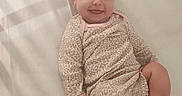 Ivy is registered to the contest to win money with this photo: baby, child, cute, expression, face, happy, head, indoors, infant, leopard_print, light, lying_down, onesie, person, playful, shadow_pattern, skin, smiling, soft_surface, tongue_out