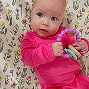 Ivy joined the competition — help win amazing prizes! baby, infant, pink_clothing, toy, ring_toy, floral_blanket, pattern, child, cute, portrait, indoor, laying_down, blue_eyes, small_hands, soft_lighting, colorful, playful, young_child, looking_away, cozy