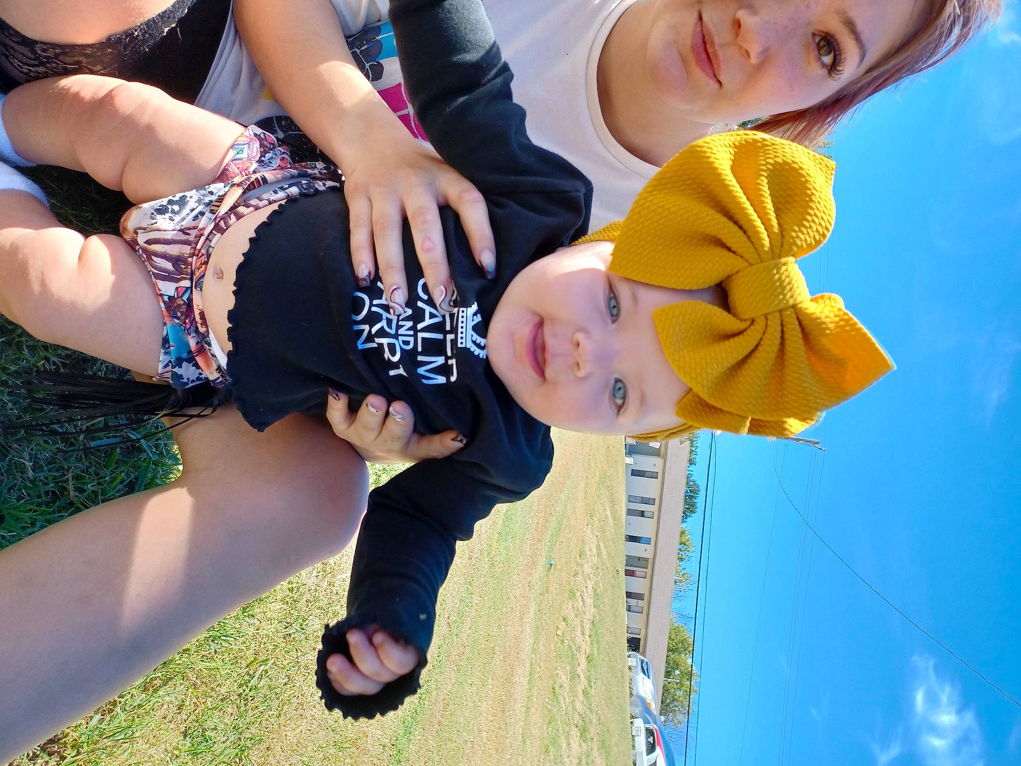 Avery is registered to the contest to win money with this photo: child, cool, daytime, electric_blue, eyewear, fun, gesture, grass, happy, hat, headwear, human_leg, leisure, people_in_nature, person, plant, recreation, sky, thigh, toddler