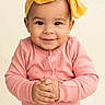 toddler, child, baby, smile, face, headband, yellow_bow, pink_clothing, long_sleeve, hands, portrait, cute, happy, infant, studio, neutral_background, young_child, person, indoors, fashion