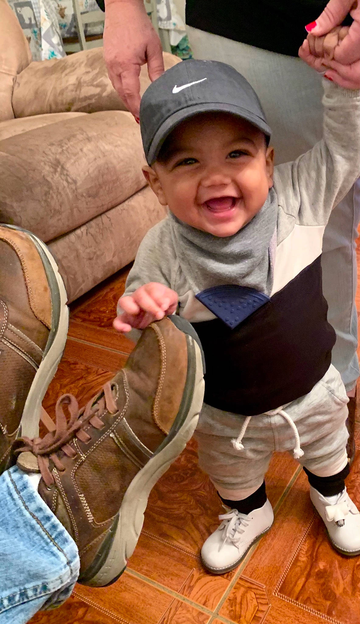 Taylin joined the competition — help win amazing prizes! baby_toddler_clothing, baseball_cap, beige, brown, cap, cool, couch, cricket_cap, finger, footwear, hand, headwear, joy, khaki, living_room, person, shoe, sneakers, studio_couch, tan