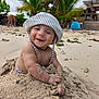 baby, child, sand, beach, smiling, hat, sunhat, toddler, outdoor, nature, palm_tree, vacation, holiday, happy, sand_play, portrait, sunny, coast, water, person