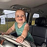baby, child, smiling, car_seat, vehicle_interior, blue_eyes, green_tank_top, happy, infant, seat, hand, window, daylight, fence, outdoor_view, portrait, cute, young_child, car, leisure