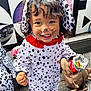 toddler, child, costume, dalmatian, face_paint, smile, snack, chips, outdoor, wooden_deck, black_and_white, pattern, floppy_ears, cute, happy, clothing, portrait, person, fun, playful