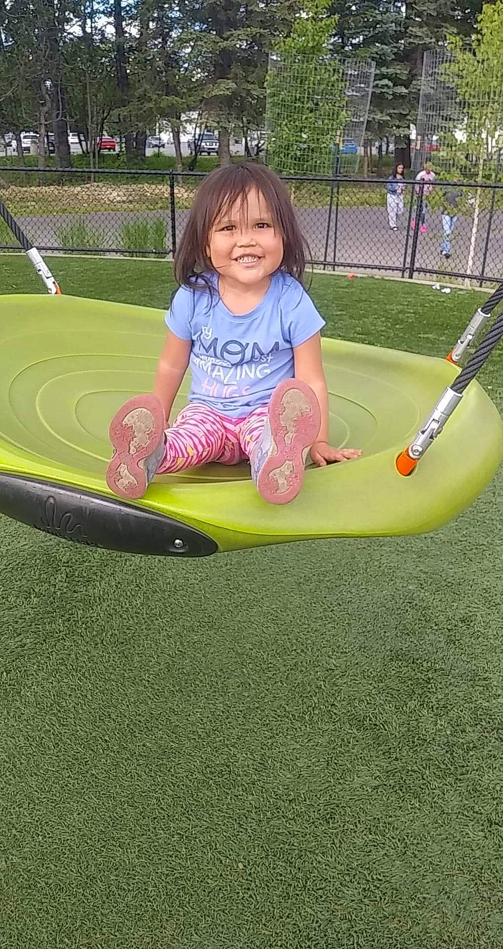 Sherry is registered to the contest to win money with this photo: child, city, grass, human_settlement, joy, leisure, outdoor_play_equipment, person, play, playground, public_space, recreation