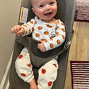 Lynx joined the competition — help win amazing prizes! baby, baby_rocker, barefoot, basketball_pattern, child, clothing, cute, floor, gray, happy, indoor, infant, joyful, light, onesie, person, reaching, rug, seated, smiling