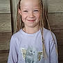 child, braids, smile, shirt, kitten, butterfly_wings, long_sleeve, pastel_color, wooden_background, portrait, happy, cute, blonde_hair, fashion, indoor, person, young, girl, casual, glitter