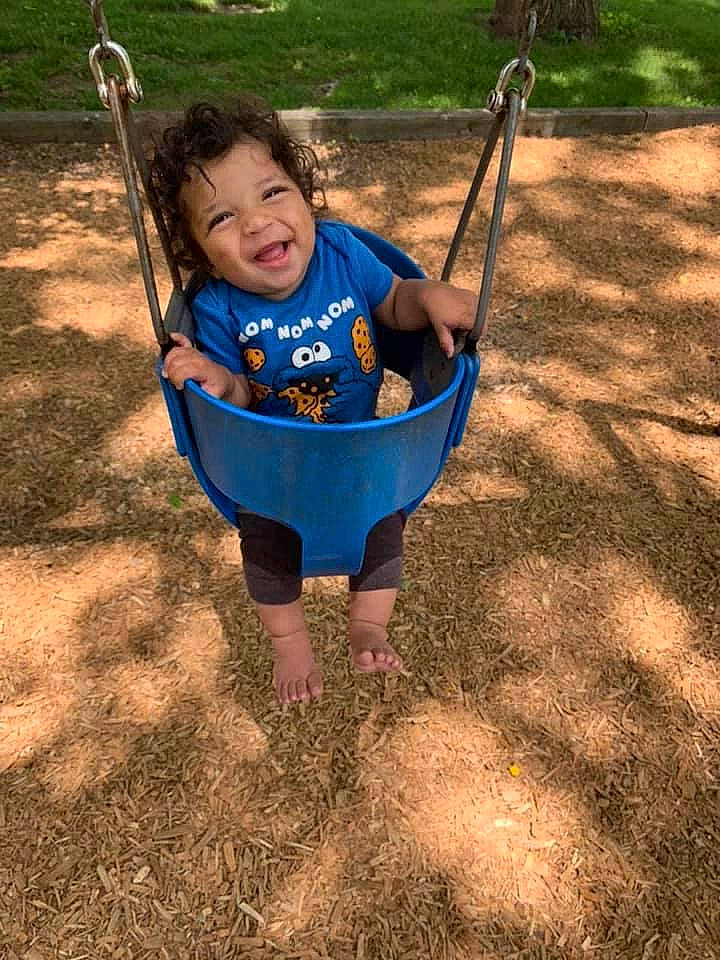 Khalil joined the competition — help win amazing prizes! baby, baby_toddler_clothing, child, city, electric_blue, face, fun, grass, happy, leisure, outdoor_play_equipment, people_in_nature, person, play, playground, recreation, smile, soil, swing, toddler