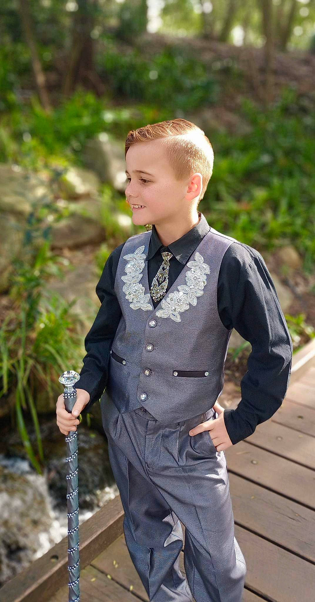 Declan is registered to the contest to win money with this photo: belt, blazer, bow_tie, collar, dress, dress_shirt, fashion_accessory, formal_wear, grass, jewellery, joy, neck, pattern, person, personal_protective_equipment, plant, recreation, sleeve, t_shirt, uniform