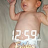 baby, infant, child, lying_down, bed, bedding, diaper, newborn, portrait, face, smiling, happy, arms_raised, indoor, bedroom, digital_clock, friday_text, text_overlay, flash_photography, close_up