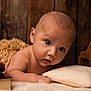 Jae-Oh participe au concours pour gagner de l'argent avec cette photo : baby, infant, child, pillow, blanket, wooden_toy, pinecone, soft_texture, curious_eyes, close_up, portrait, indoor, warm_lighting, skin, cute, resting, cozy, homedecor, wood_background, toddler