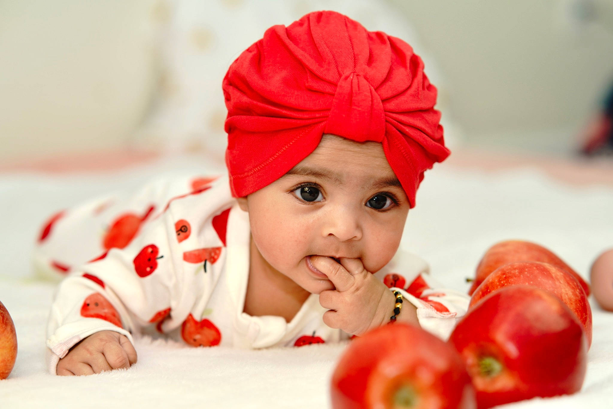 Sitara is registered to the contest to win money with this photo: baby, cap, carmine, child, costume_hat, event, eye, food, fruit, happy, hat, headwear, holiday, human_body, lip, natural_foods, person, produce, santa_claus, superfood