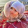 baby, child, hat, jacket, blanket, outdoor, lake, mountain, nature, pacifier, smile, cute, portrait, infant, warm_clothing, red_blanket, sunlight, face, young_child, scenery