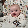 Journey joined the competition — help win amazing prizes! baby, smiling, blanket, high_chair, animal_pattern, cute, happy, infant, indoors, soft_texture, clothing, mittens, face, child, portrait, seated, warm, comfort, expression, cozy
