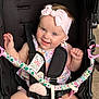 Rosie joined the competition — help win amazing prizes! baby, child, smiling, headband, pink, stroller, toy, happy, cute, blue_eyes, infant, clothing, seatbelt, person, portrait, outdoor, playful, sitting, accessory, toddler