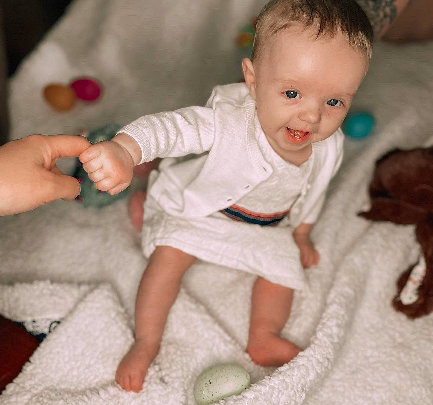 Madison is registered to the contest to win money with this photo: baby, baby_toddler_clothing, cheek, comfort, dress, face, finger, floor, flooring, hand, leg, mammal, person, pink, product, skin, sleeve, smile, textile, toddler