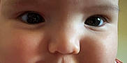 Lyla joined the competition — help win amazing prizes! baby, close_up, face, chubby_cheeks, infant, cute, person, child, indoor, clothing, pattern, shirt, skin, head, eyes, mouth, portrait, young, adorable, soft_light