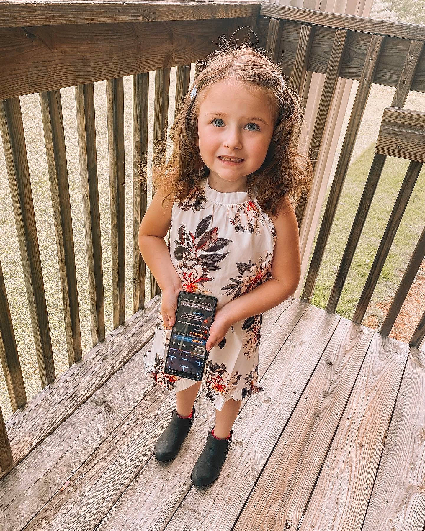 Koda is registered to the contest to win money with this photo: dress, face, footwear, grass, happy, hardwood, human_leg, joy, leg, leisure, pattern, people_in_nature, person, plank, plant, smile, street_fashion, thigh, tree, waist