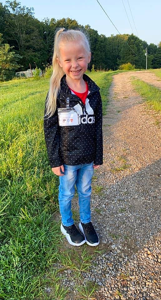 Anna is registered to the contest to win money with this photo: baby_toddler_clothing, clothing, denim, face, grass, grassland, hair, happy, head, jeans, joy, meadow, people_in_nature, person, plant, sleeve, smile, standing, street_fashion, t_shirt