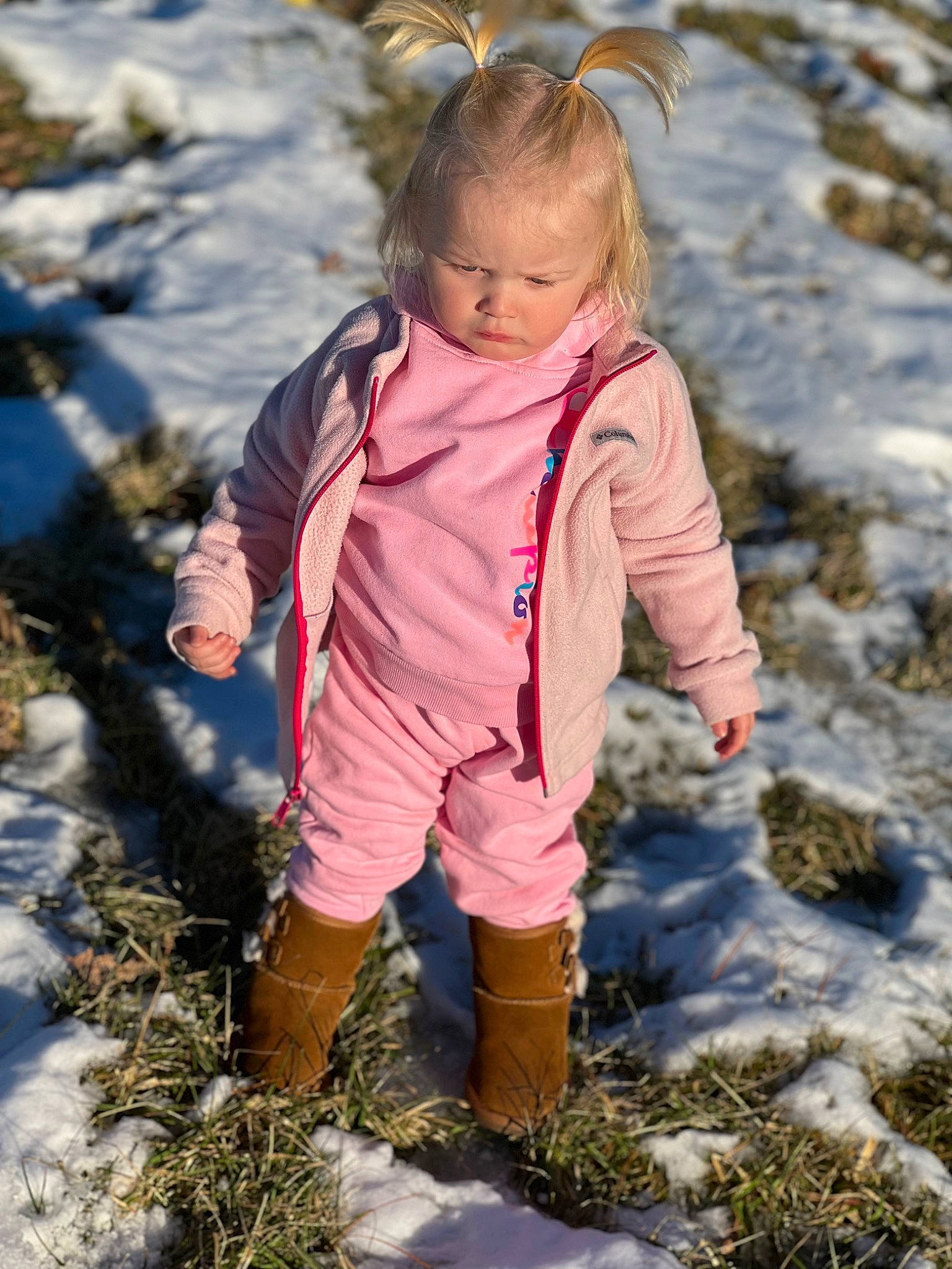 Ariah is registered to the contest to win money with this photo: body_of_water, child, clothing, face, freezing, fun, grass, hair, happy, landscape, people_in_nature, person, plant, puddle, recreation, sand, snow, soil, toddler, winter