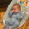 animal_print, baby, child, clothing, comfort, cute, face, foot, hand, indoors, infant, pajamas, pattern, peaceful, rainbow, resting, rocker, sleeping, toy, wooden_floor