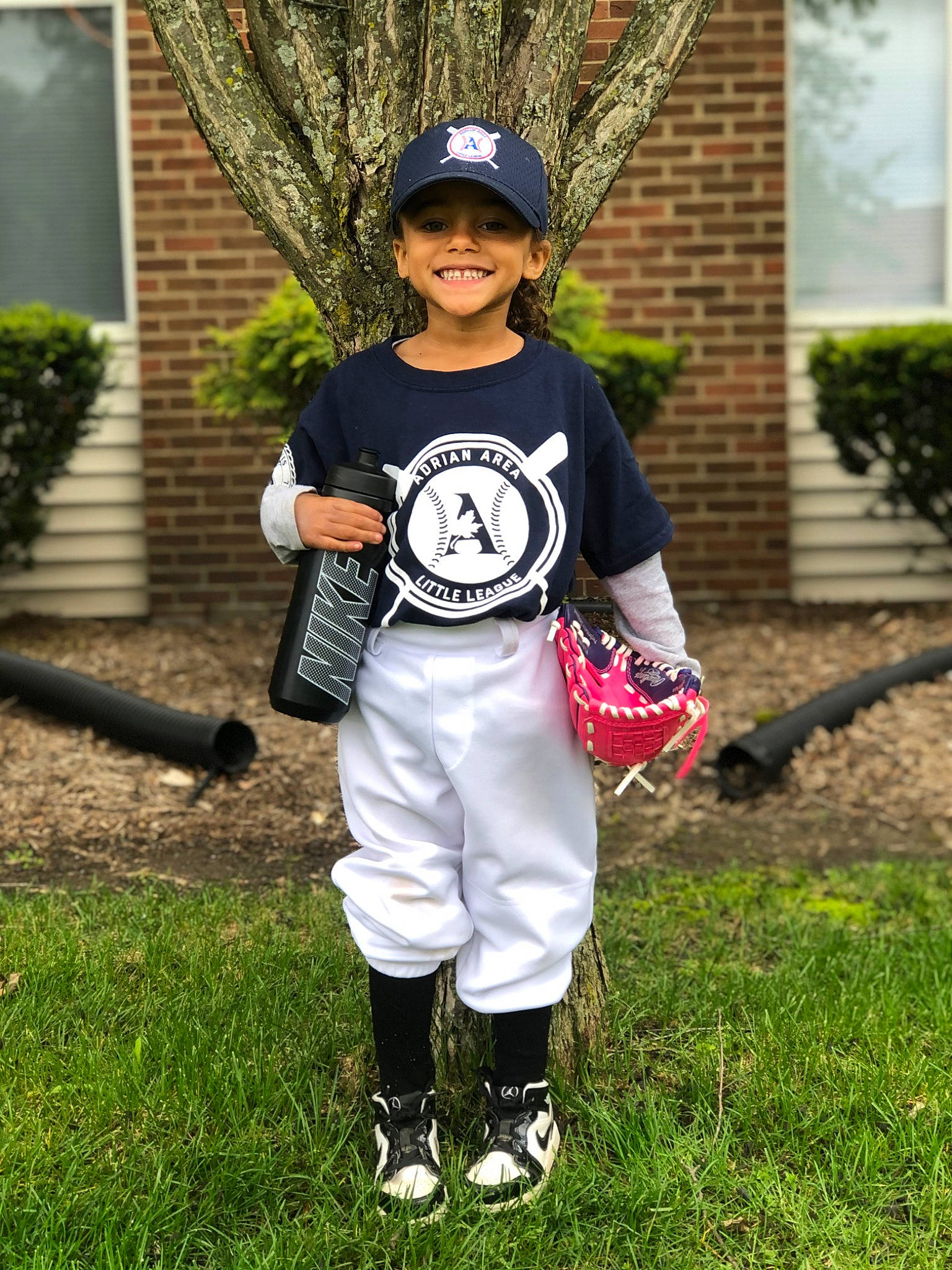 Myah is registered to the contest to win money with this photo: baseball_cap, baseball_equipment, baseball_glove, cap, glove, hat, headgear, headwear, helmet, jersey, joy, outerwear, person, plant, player, sleeve, sneakers, sports_equipment, sports_gear, sports_uniform