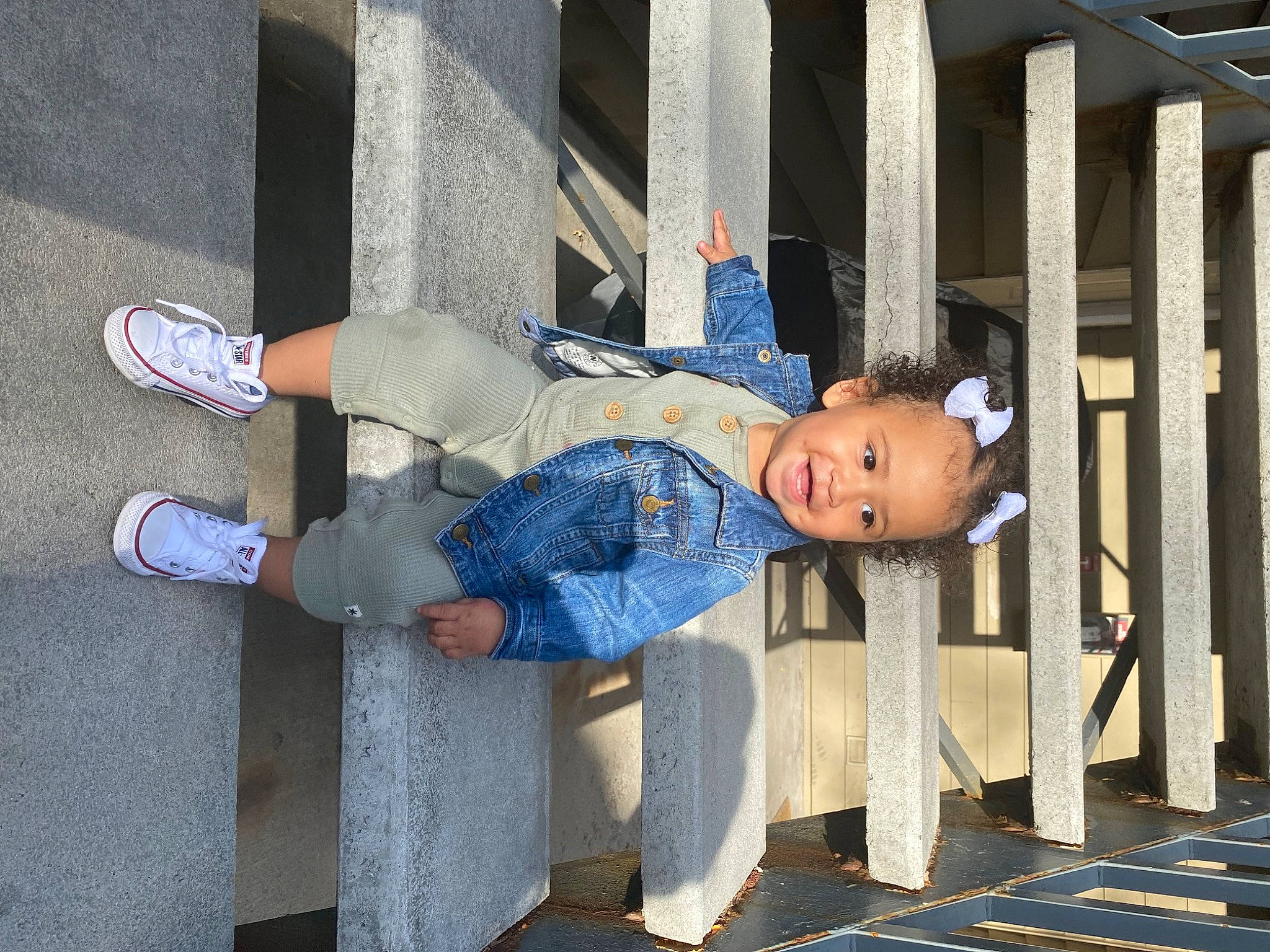 Reina is registered to the contest to win money with this photo: baby_toddler_clothing, child, denim, electric_blue, foot, fun, hat, human_leg, knee, leisure, line, outdoor_shoe, person, sitting, sleeve, smile, sneakers, thigh, toddler, walking_shoe