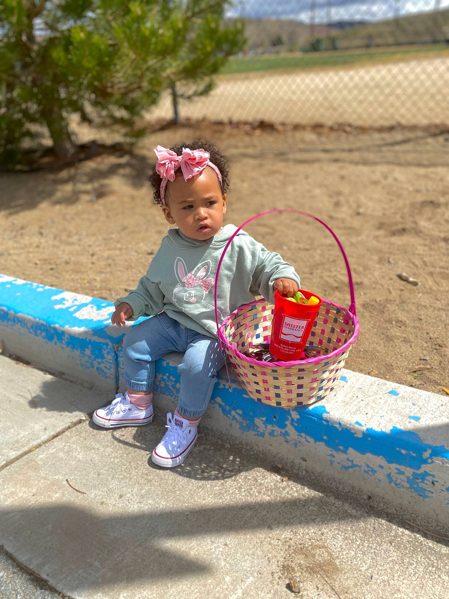 Reina is registered to the contest to win money with this photo: basket, child, fashion_accessory, fun, grass, hat, landscape, leisure, people_in_nature, person, play, recreation, sand, shoe, sitting, sneakers, soil, tire, toddler, travel
