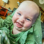 Adalynn joined the competition — help win amazing prizes! baby, smiling, blue_eyes, green_sweater, indoor, living_room, child, happy, cute, portrait, face, infant, cozy, fabric, apparel, person, home, furniture, cheerful, closeup
