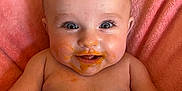 Chloe Ann joined the competition — help win amazing prizes! baby, infant, smile, messy_face, food, orange_food, pink_blanket, happy, cute, child, skin, bare_chest, lying_down, closeup, face, eyes, mouth, cheeks, expression, indoor