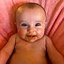 baby, infant, smile, messy_face, food, orange_food, pink_blanket, happy, cute, child, skin, bare_chest, lying_down, closeup, face, eyes, mouth, cheeks, expression, indoor