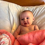 Chloe Ann is registered to the contest to win money with this photo: baby, blanket, pillow, wood, smiling, infant, cute, face, skin, child, indoors, bed, comfort, soft, young, portrait, resting, cozy, happy, headboard